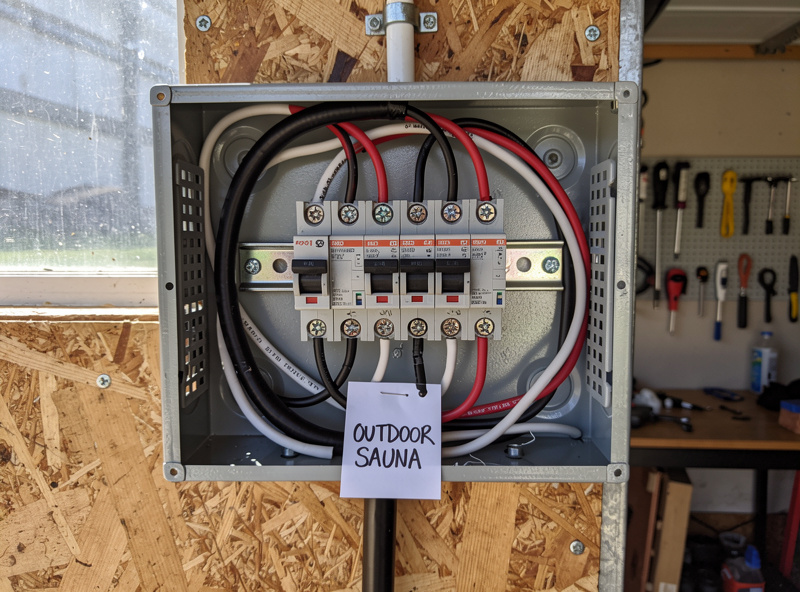 Electrical panel with dedicated 30-amp 240V breaker labeled Outdoor Sauna
