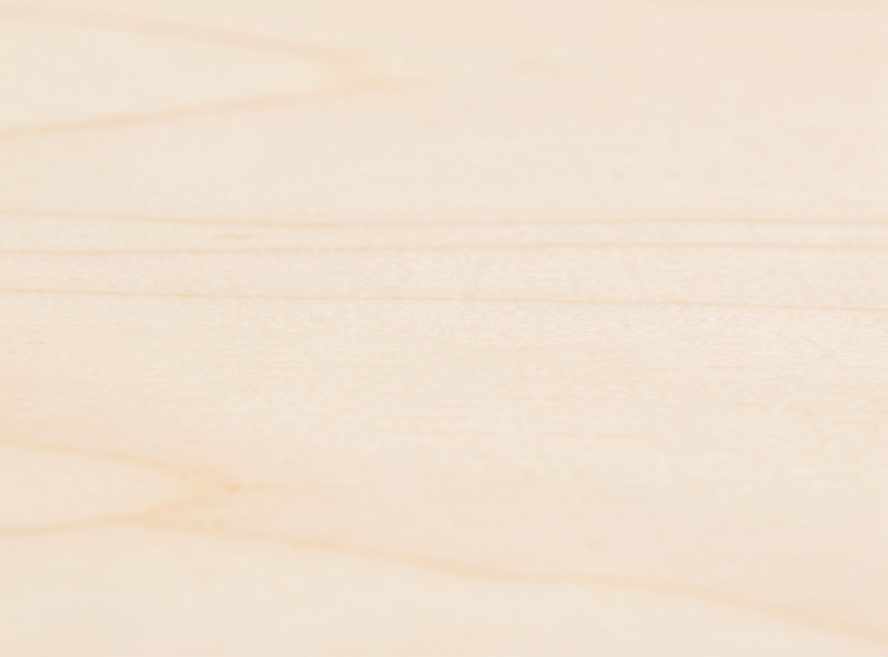 Close-up of pale smooth fine-grained basswood board showing uniform light color