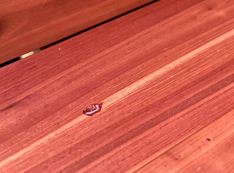 Reddish western red cedar sauna boards showing grain and a small resin streak
