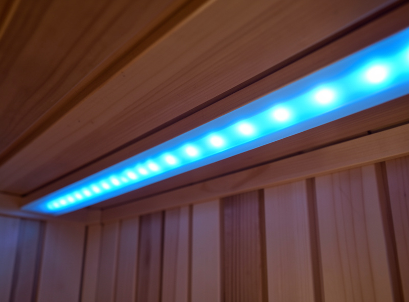 Infrared sauna interior lit with a soft blue chromotherapy LED bar along the ceiling