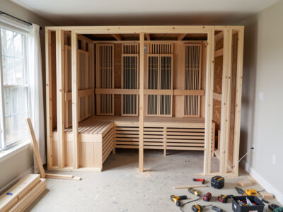 DIY infrared sauna build beside a prefab cabin comparing where the cost goes