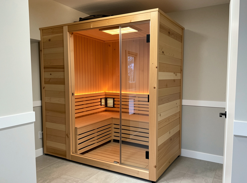 A finished DIY infrared sauna built into a converted closet with bench and panels