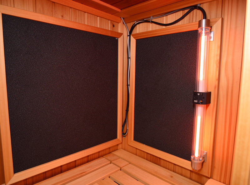 Infrared sauna cabin interior showing carbon far-infrared panels and a near-infrared emitter on a dedicated circuit