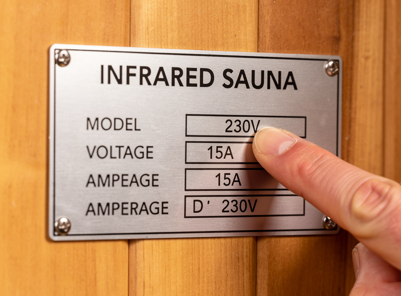 Close-up of an infrared sauna nameplate label showing voltage and amperage ratings