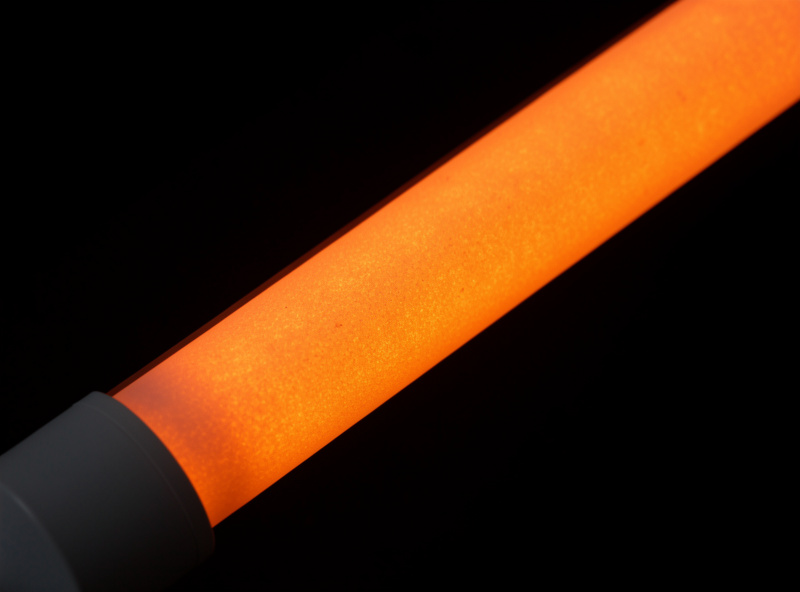 Diagram-style photo of a ceramic sauna heater rod glowing, illustrating mid-infrared output