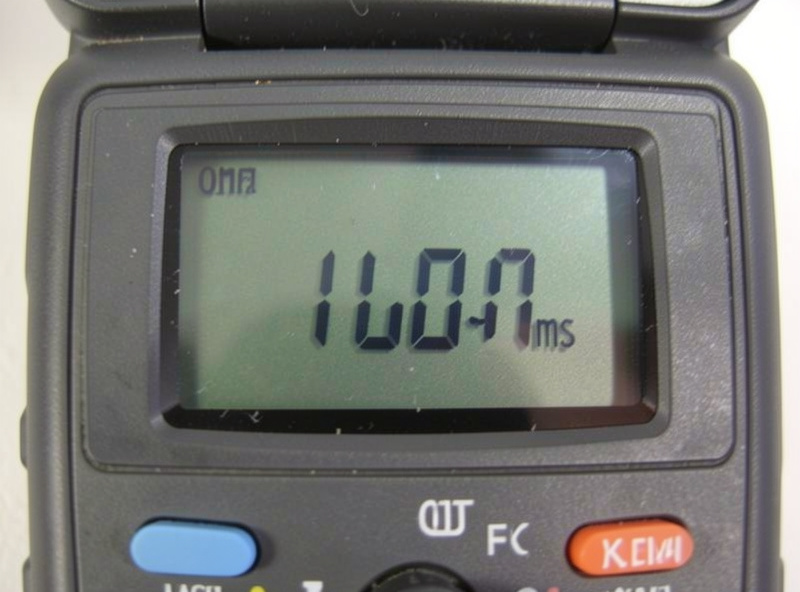 Multimeter displaying a resistance reading while testing an infrared sauna temperature probe