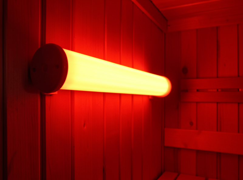 Glowing ceramic rod infrared heaters mounted on the wall of a sauna cabin
