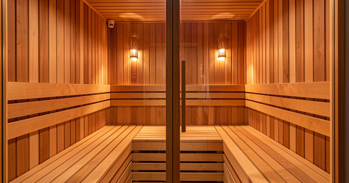 Facing-bench infrared sauna cabin with two benches on opposite hemlock walls