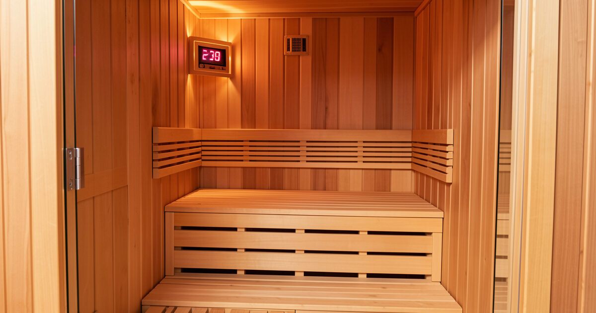Infrared sauna cabin interior with digital temperature display on the wall
