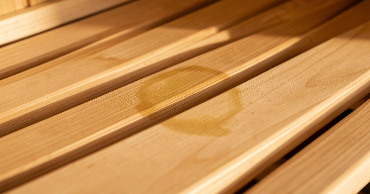 Faint yellow-brown sweat stain shadow on a hemlock infrared sauna bench