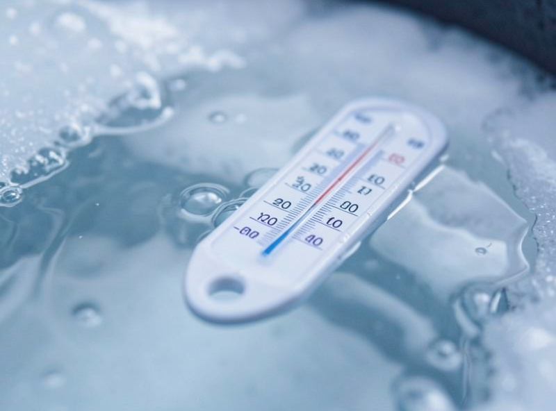 Floating thermometer showing a low temperature in a cold plunge tub